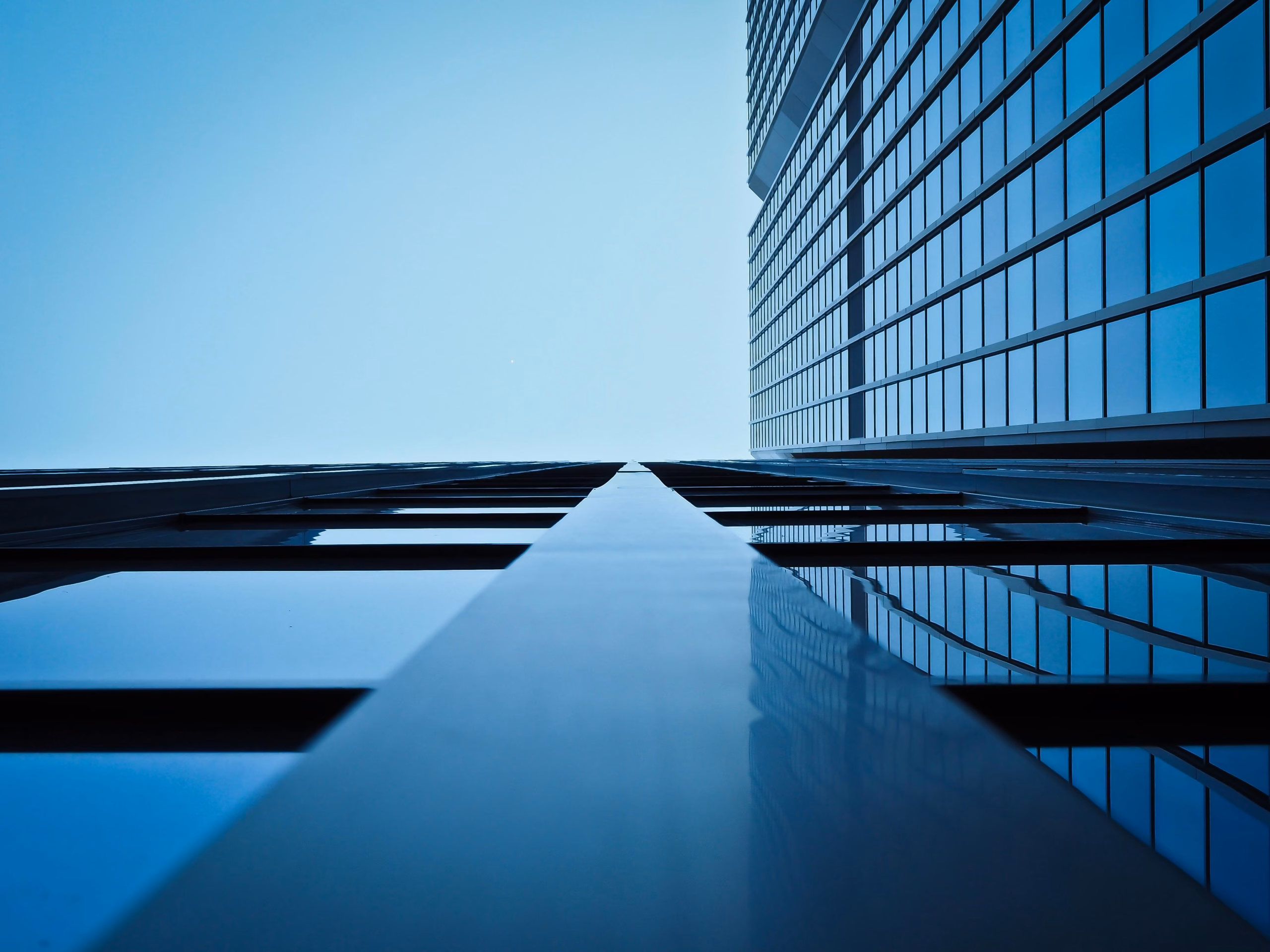 A stock photo of modern office building exterior integrated with a luxury shopping mall landscape