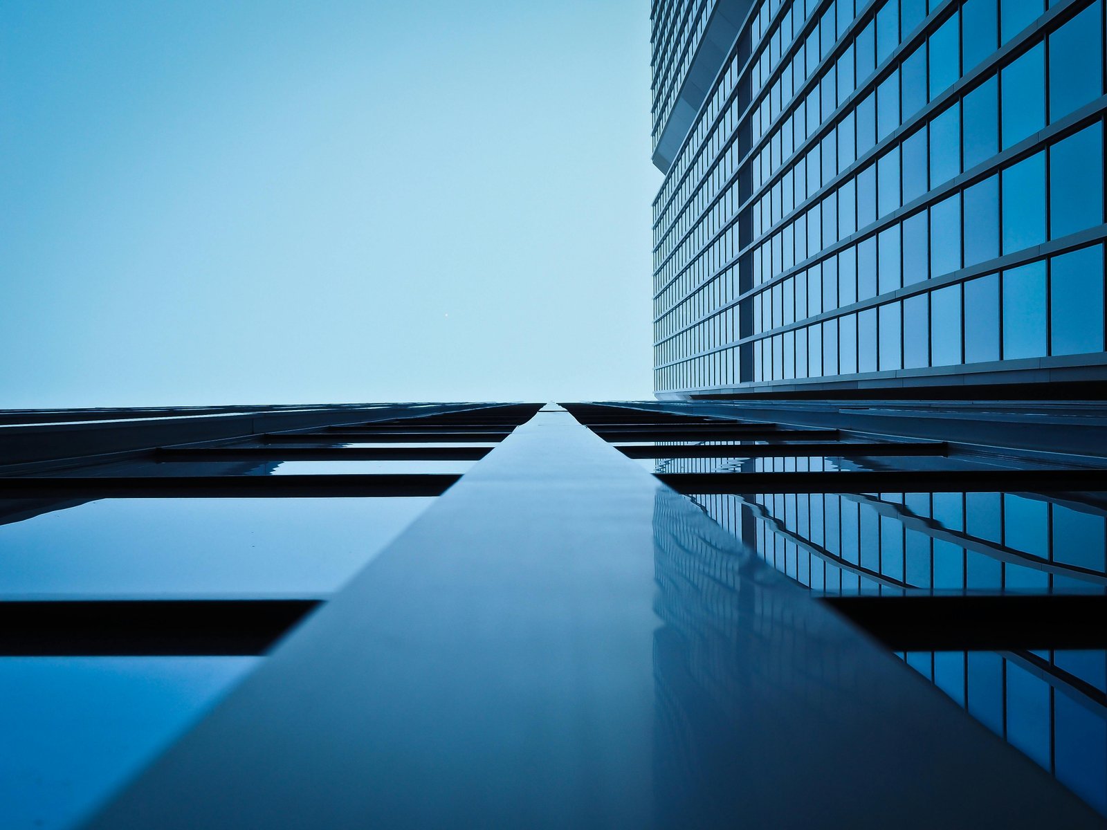 A stock photo of modern office building exterior integrated with a luxury shopping mall landscape
